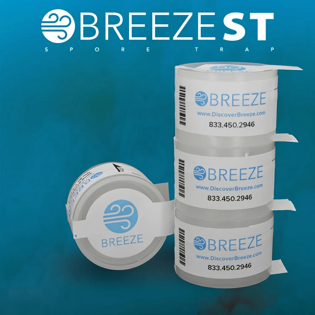 Stack of BREEZE Spore Trap cassettes for mold testing, with one cassette on its side