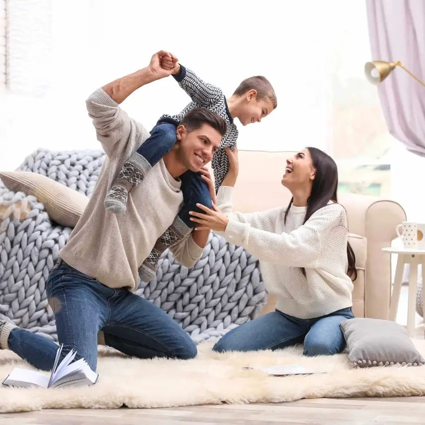 11-month warranty inspection in Chicago — Happy family playing in a living room, representing the peace of mind from a reliab