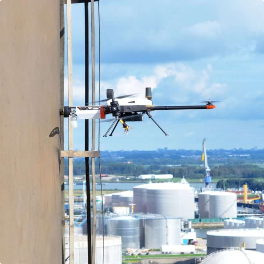 Drone flying near a building, used for technology-driven property inspections
